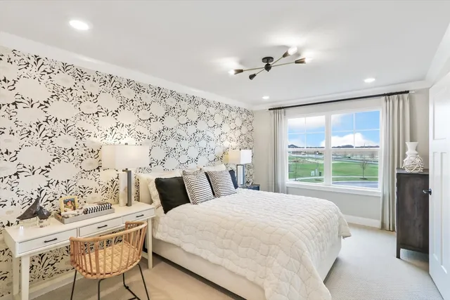 a bedroom with a large bed and a window