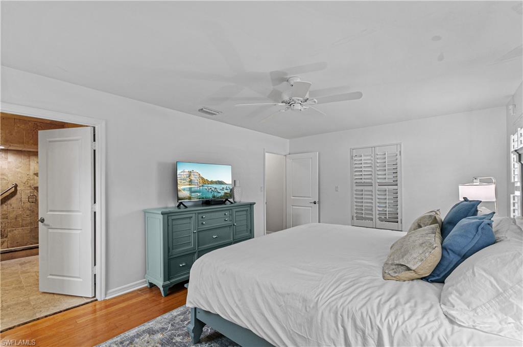 802 10th Avenue South, Unit 802 Naples, FL 34102 - Photo 11 of 13 a bedroom with a bed and a dresser in it