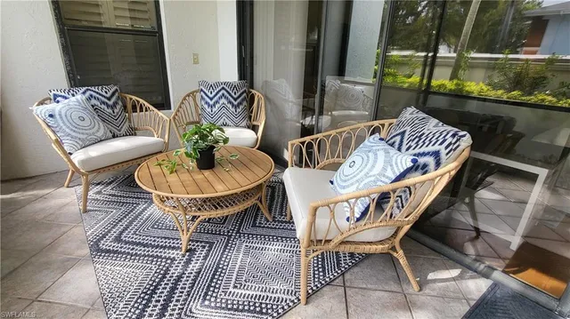 a balcony with table and chairs