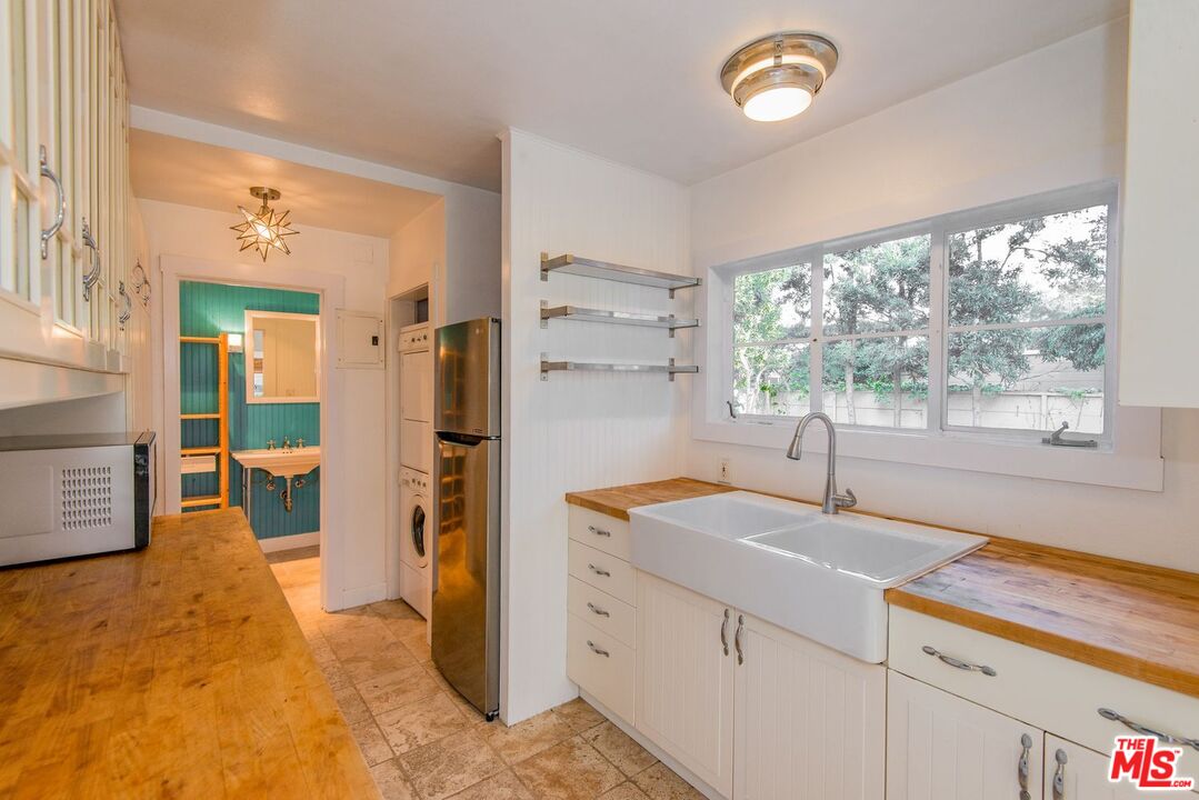 5233 Village Green Los Angeles, CA 90016 - Photo 12 of 34 a kitchen with a sink and a window