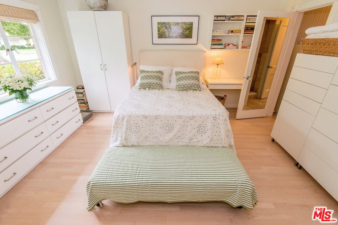 5233 Village Green Los Angeles, CA 90016 - Photo 17 of 34 a bedroom with a bed and a large window