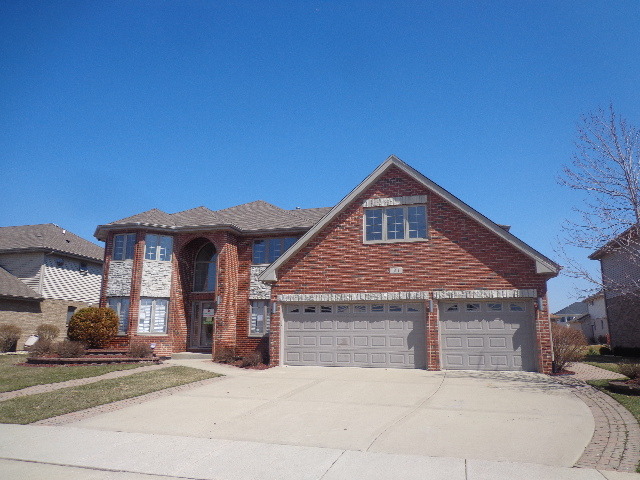 313 Homeland Road Matteson, IL 60443 - Photo 1 of 21 a front view of a house with a yard