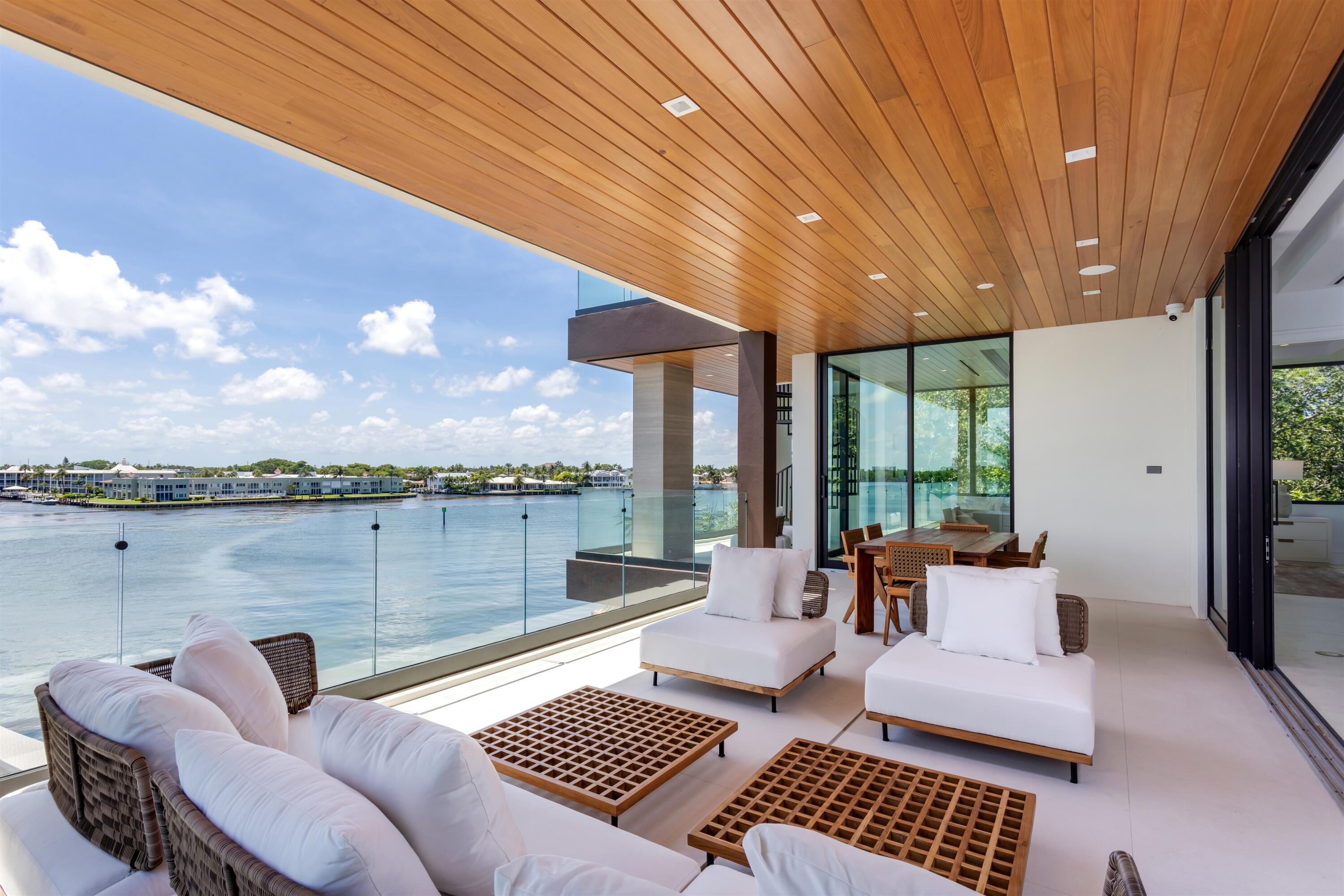 900 Lago Mar Lane, Unit PH Boca Raton, FL 33431 - Photo 32 of 58 a outdoor living space with furniture and a floor to ceiling window