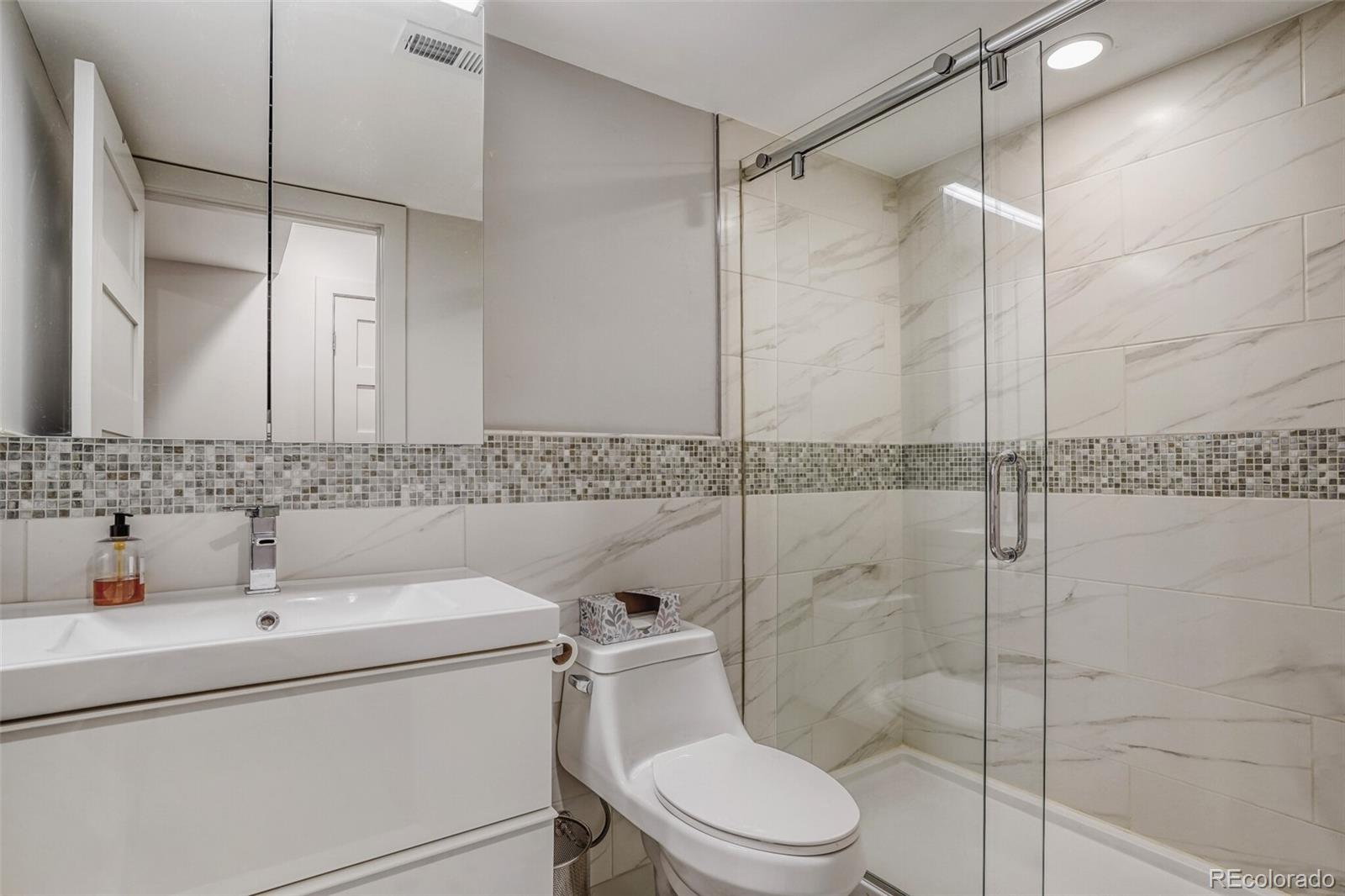 1322 South Pearl Street Denver, CO 80210 - Photo 29 of 39 a bathroom with a sink toilet and shower