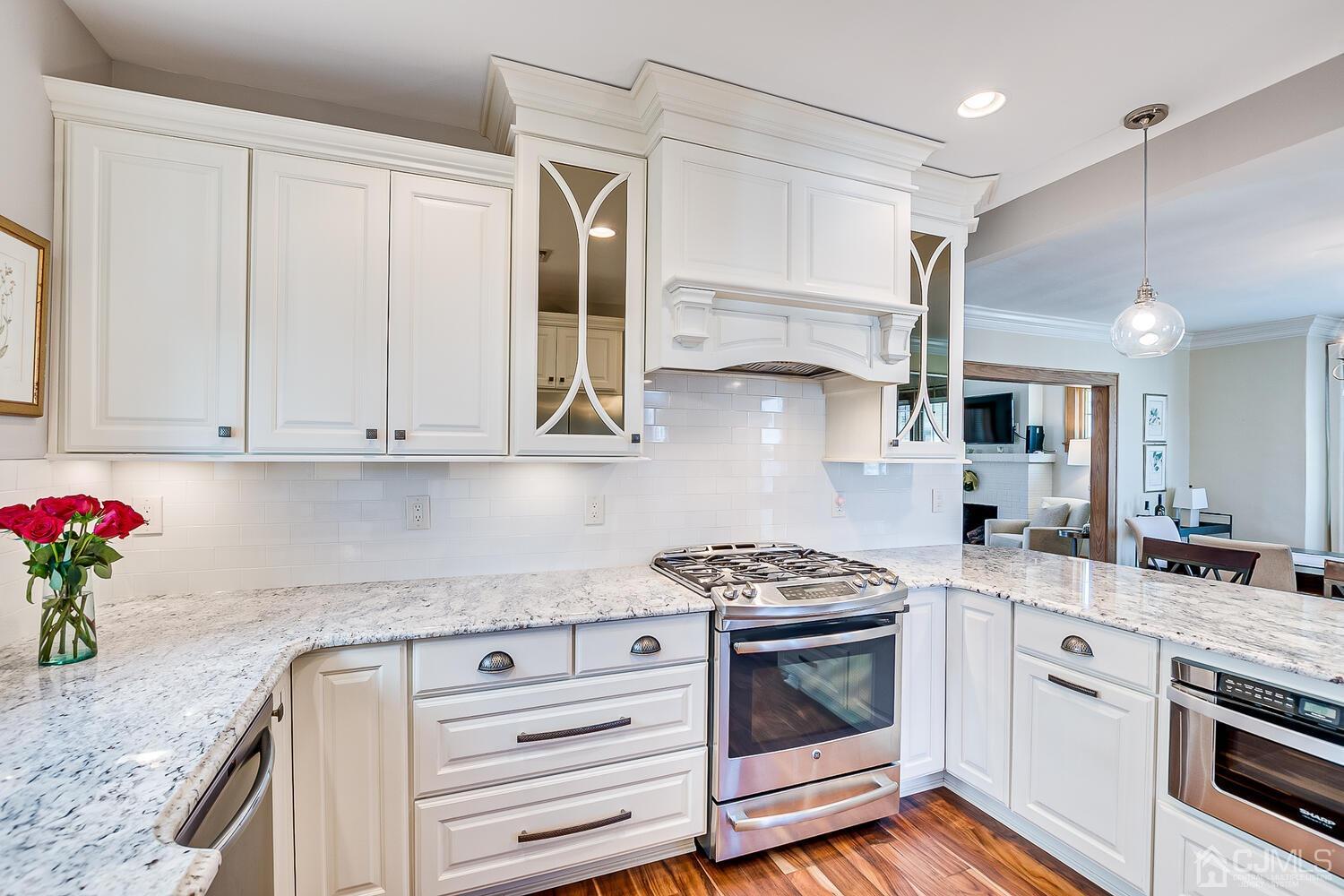 29 Jefferson Avenue Edison, NJ 08837 - Photo 19 of 36 a kitchen with granite countertop a stove sink and cabinets