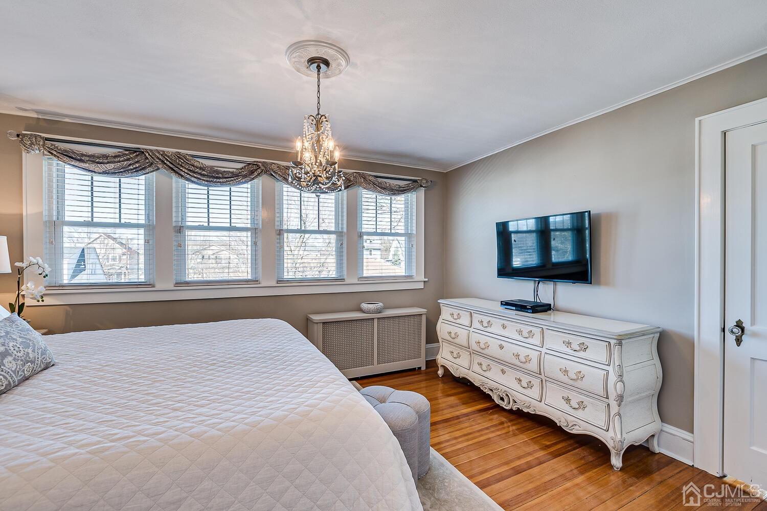 29 Jefferson Avenue Edison, NJ 08837 - Photo 22 of 36 a bedroom with a bed and a flat screen tv