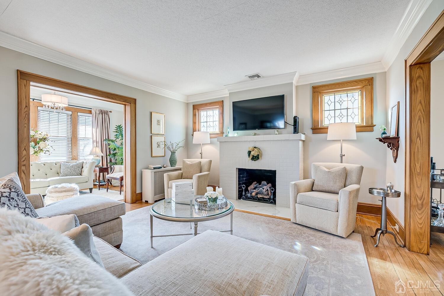 29 Jefferson Avenue Edison, NJ 08837 - Photo 6 of 36 a living room with furniture a fireplace and a flat screen tv