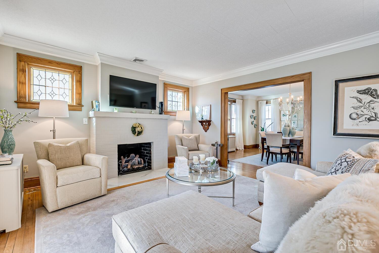 29 Jefferson Avenue Edison, NJ 08837 - Photo 7 of 36 a living room with furniture a fireplace and a flat screen tv