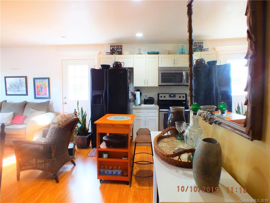 1914 Canal Road Catawba, SC 29704 - Photo 12 of 23 a living room with furniture a flat screen tv and a floor to ceiling window