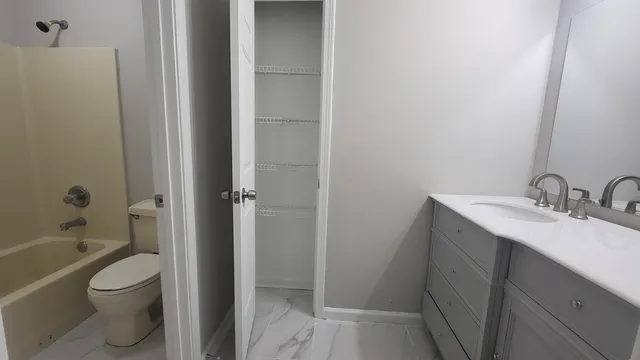 a bathroom with a sink toilet and shower
