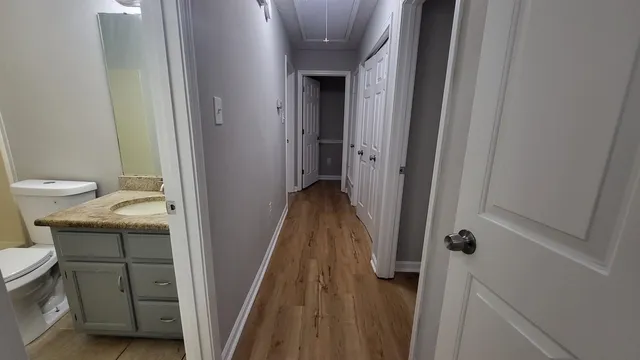 a view of a bathroom from a corridor