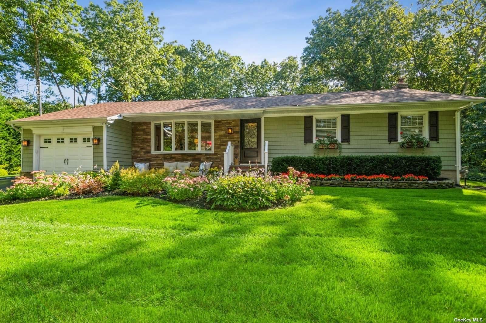 51 Laurel Drive Smithtown, NY 11787 - Photo 1 of 1 a front view of a house with a garden