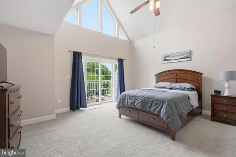 a spacious bedroom with a bed and a window