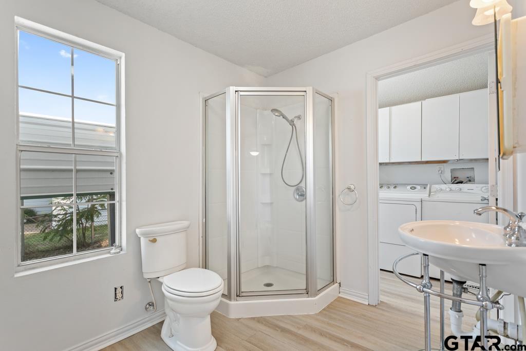 210 Cooper Street Lindale, TX 75771 - Photo 17 of 23 a bathroom with a toilet sink vanity and shower