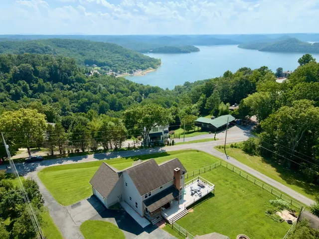 an aerial view of a house with swimming pool patio and outdoor seating