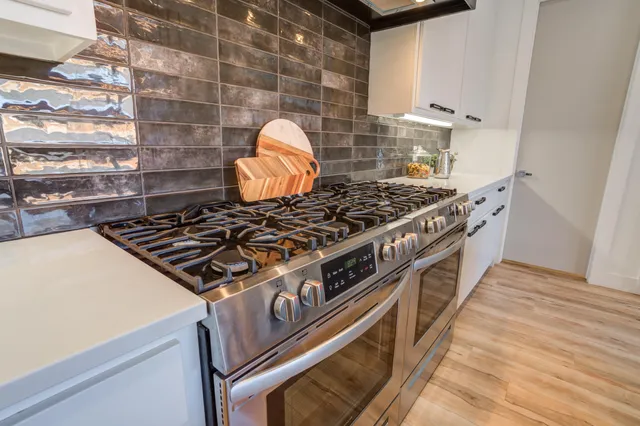a bathroom with a double vanity sink a mirror and a bathtub