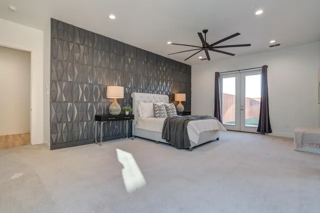 a bathroom with a granite countertop sink a toilet and a mirror