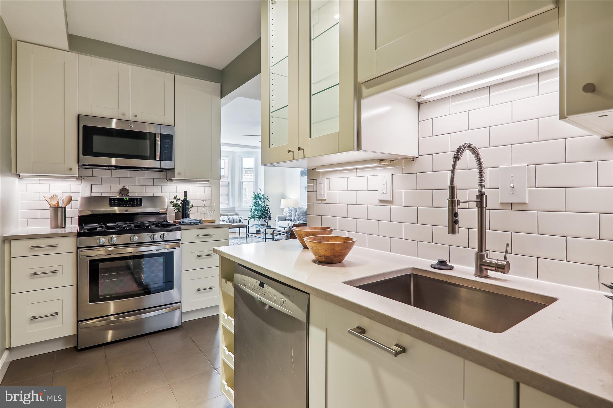 1669 Columbia Road Northwest, Unit 204 Washington, DC 20009 - Photo 12 of 42 a view with stainless steel appliances granite countertop a sink and a stove next to a window