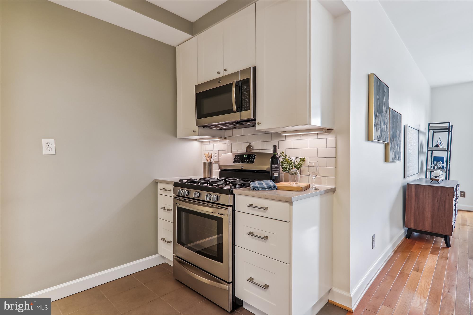 1669 Columbia Road Northwest, Unit 204 Washington, DC 20009 - Photo 13 of 42 a kitchen with stainless steel appliances white cabinets and a stove top oven
