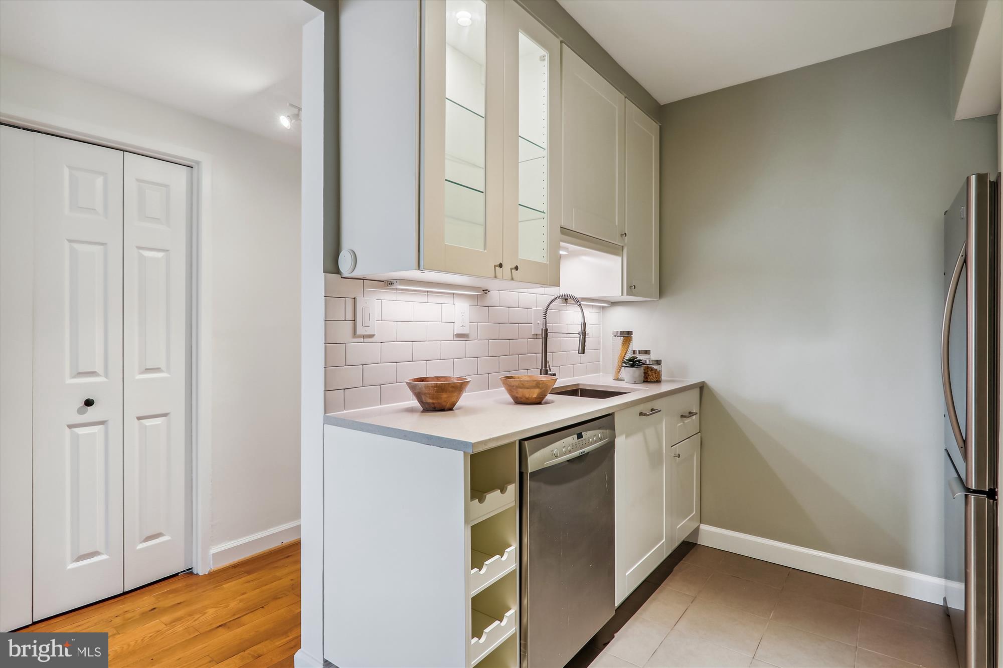 1669 Columbia Road Northwest, Unit 204 Washington, DC 20009 - Photo 14 of 42 a kitchen with a sink cabinets and a window