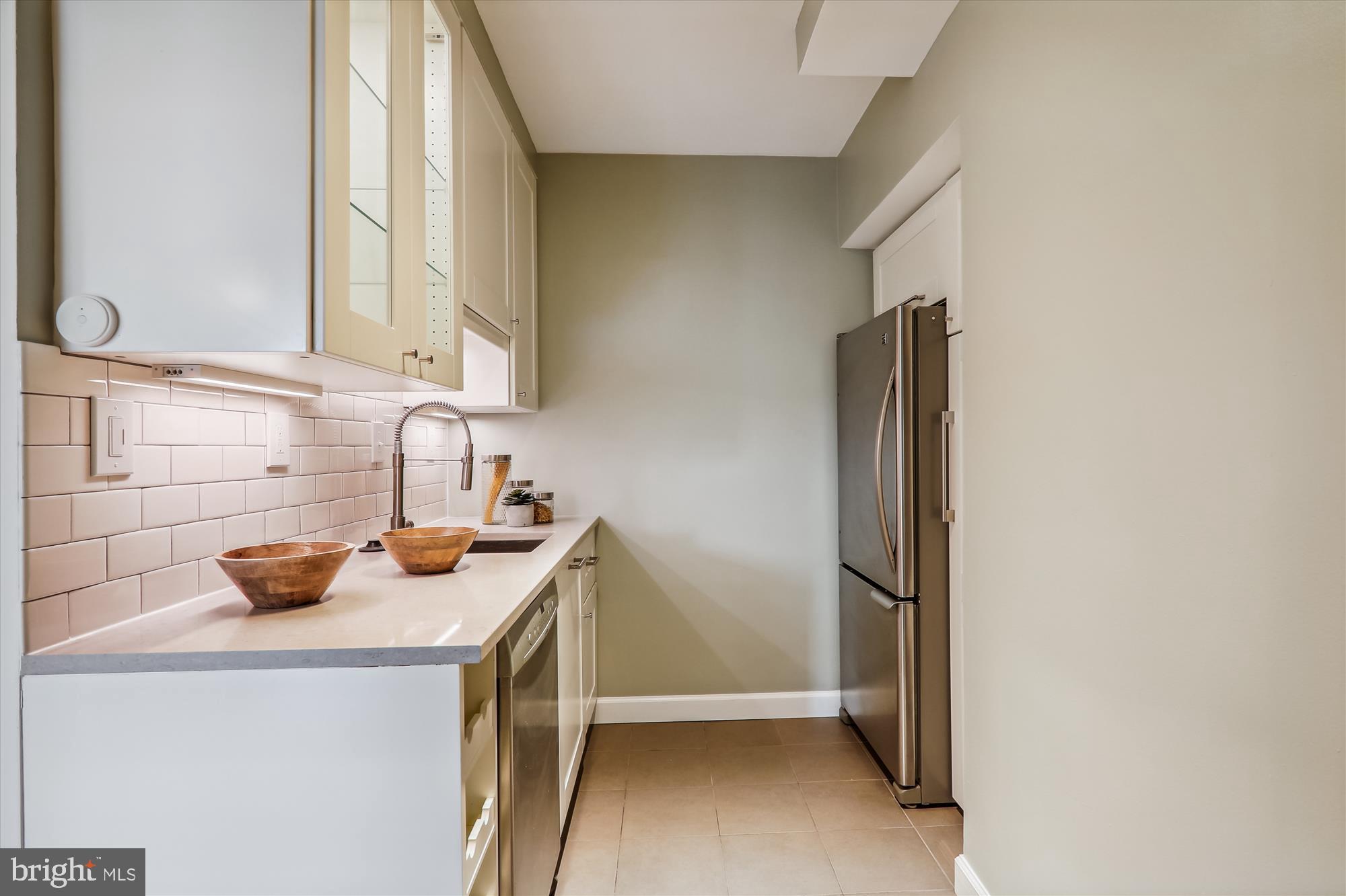 1669 Columbia Road Northwest, Unit 204 Washington, DC 20009 - Photo 15 of 42 a kitchen with a sink and a refrigerator
