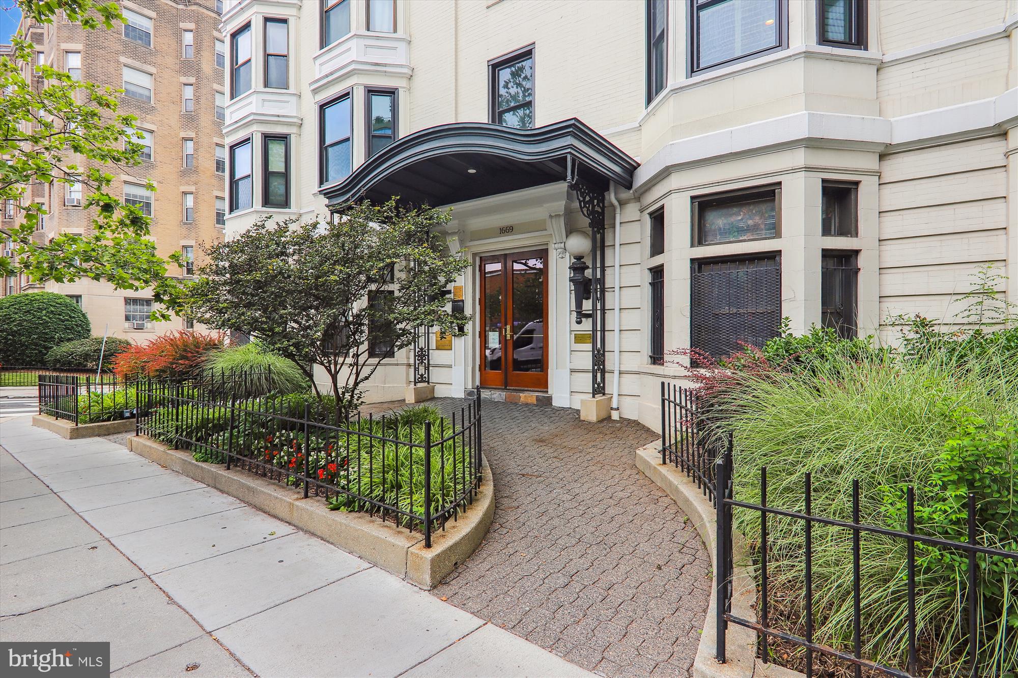 1669 Columbia Road Northwest, Unit 204 Washington, DC 20009 - Photo 2 of 42 a front view of a house with a garden