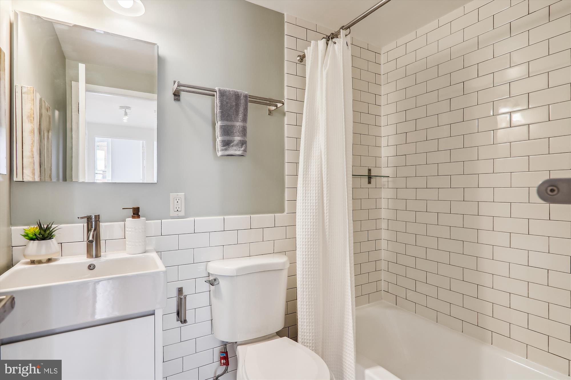 1669 Columbia Road Northwest, Unit 204 Washington, DC 20009 - Photo 21 of 42 a bathroom with a sink toilet and shower