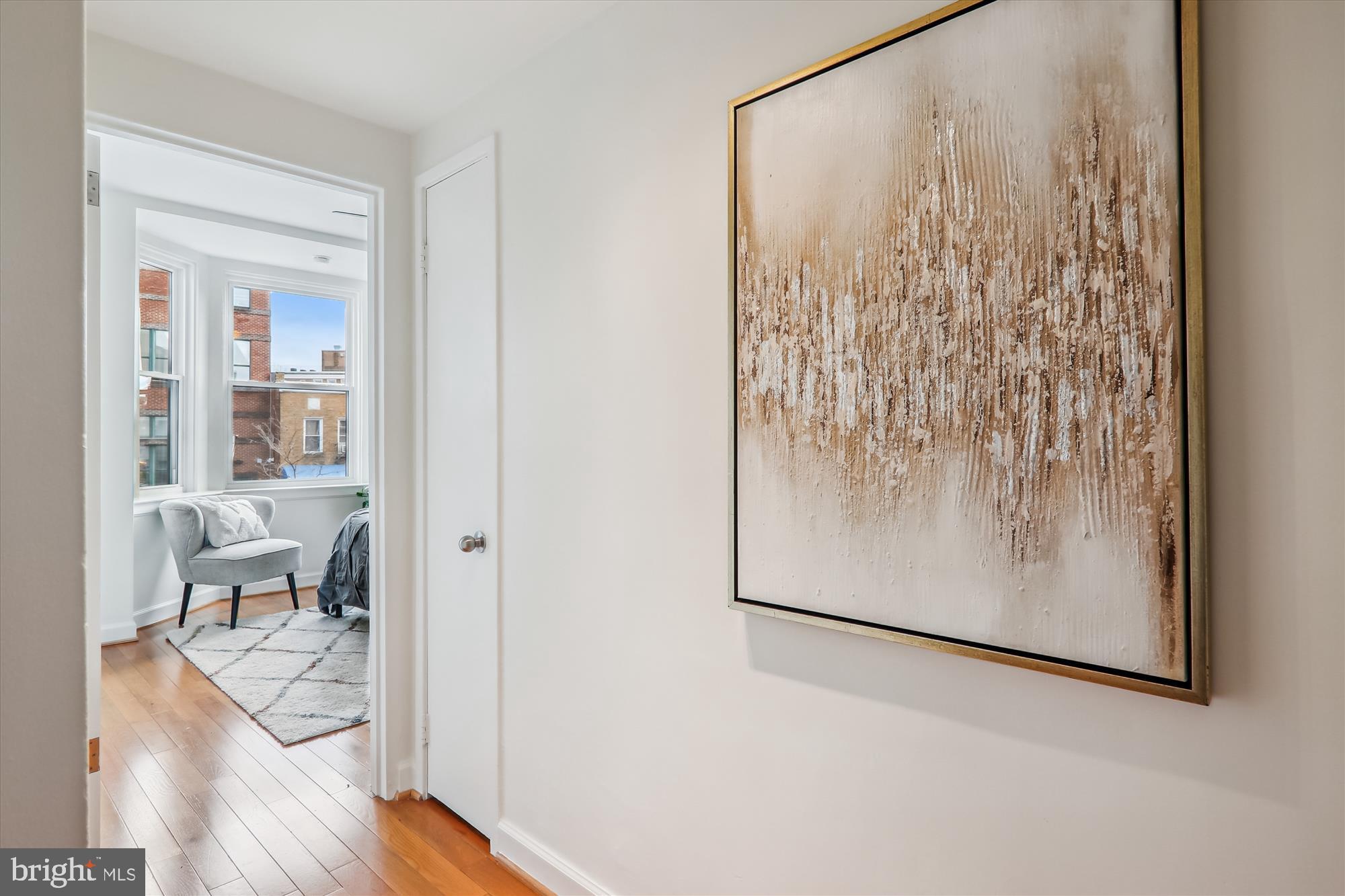 1669 Columbia Road Northwest, Unit 204 Washington, DC 20009 - Photo 22 of 42 a view of a room with wooden floor and a window