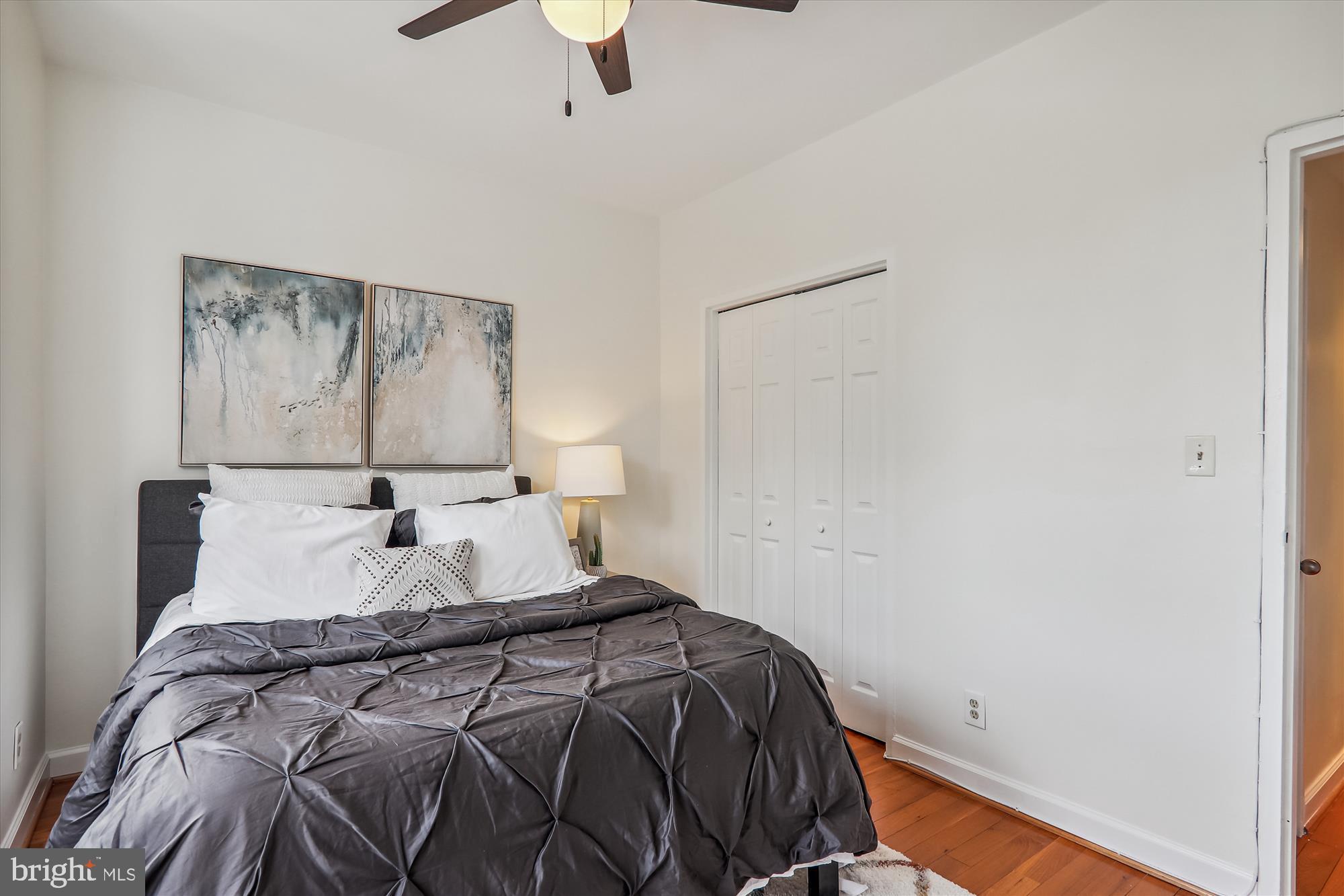 1669 Columbia Road Northwest, Unit 204 Washington, DC 20009 - Photo 24 of 42 a bedroom with a bed and a painting on the wall