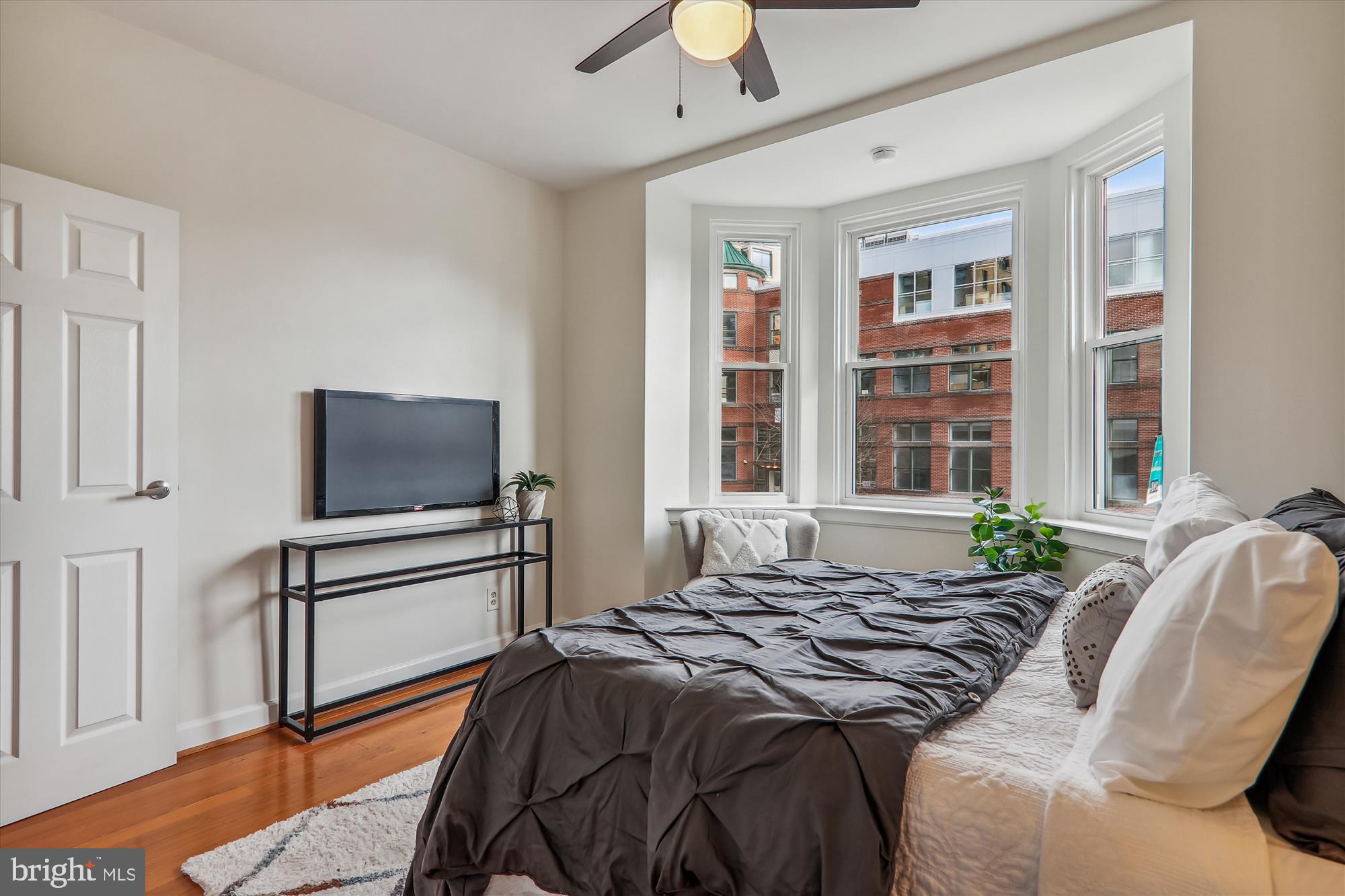 1669 Columbia Road Northwest, Unit 204 Washington, DC 20009 - Photo 25 of 42 a bedroom with a bed and a flat screen tv