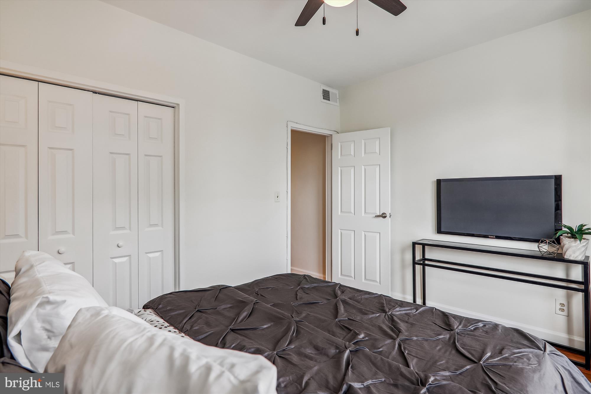 1669 Columbia Road Northwest, Unit 204 Washington, DC 20009 - Photo 26 of 42 a bedroom with a bed and a flat screen tv