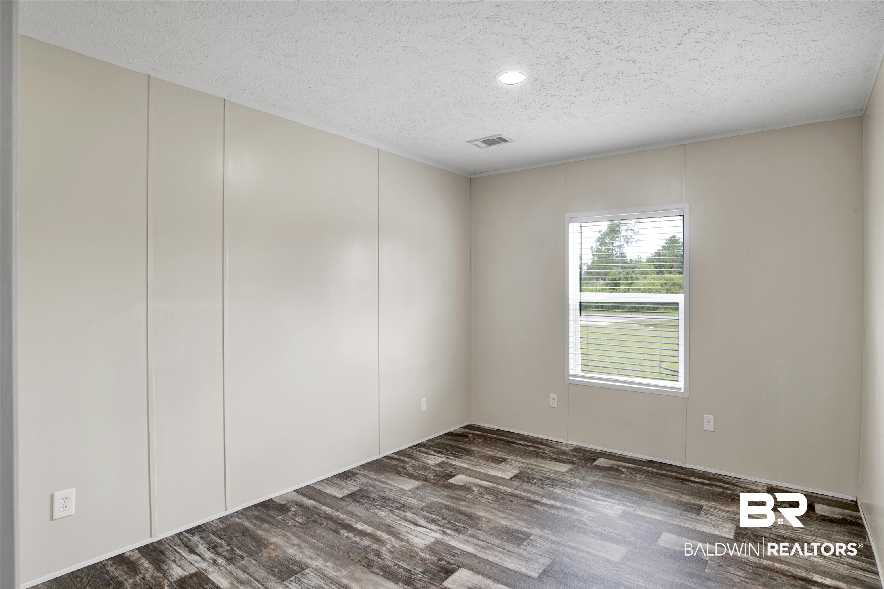 16778 County Road 87 Elberta, AL 36530 - Photo 26 of 32 Unfurnished room with dark wood-type flooring and a textured ceiling