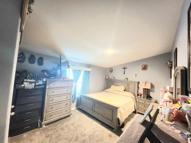 a bedroom with a bed and cabinets