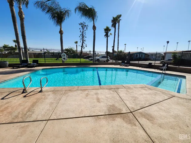 a lawn chairs sitting on a swimming pool