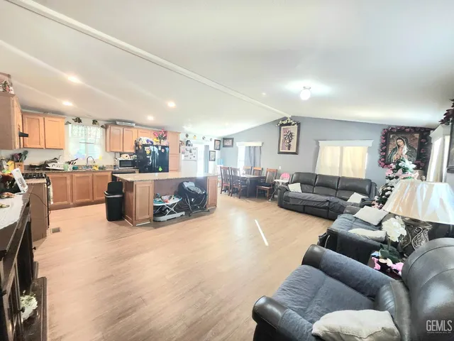 a living room with furniture and kitchen view