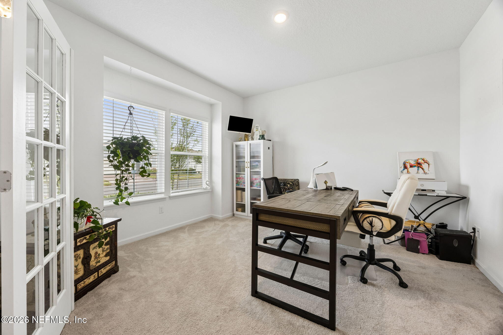 75626 Pondside Lane Yulee, FL 32097 - Photo 11 of 95 a view of a workspace with furniture and a window