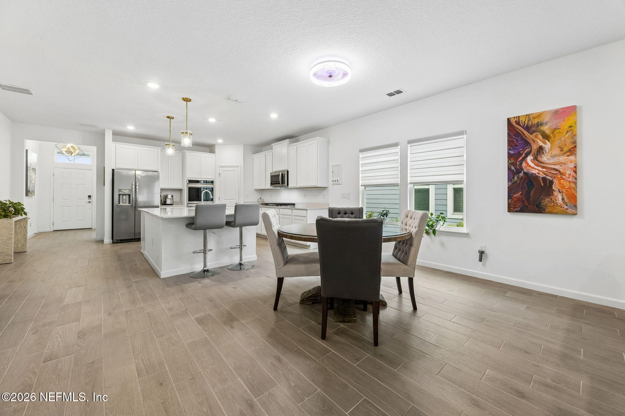 75626 Pondside Lane Yulee, FL 32097 - Photo 20 of 95 a view of a dining room with furniture window and wooden floor