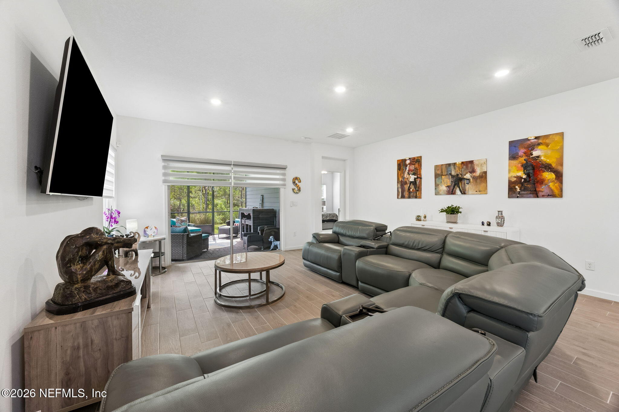 75626 Pondside Lane Yulee, FL 32097 - Photo 25 of 95 a living room with furniture and a flat screen tv