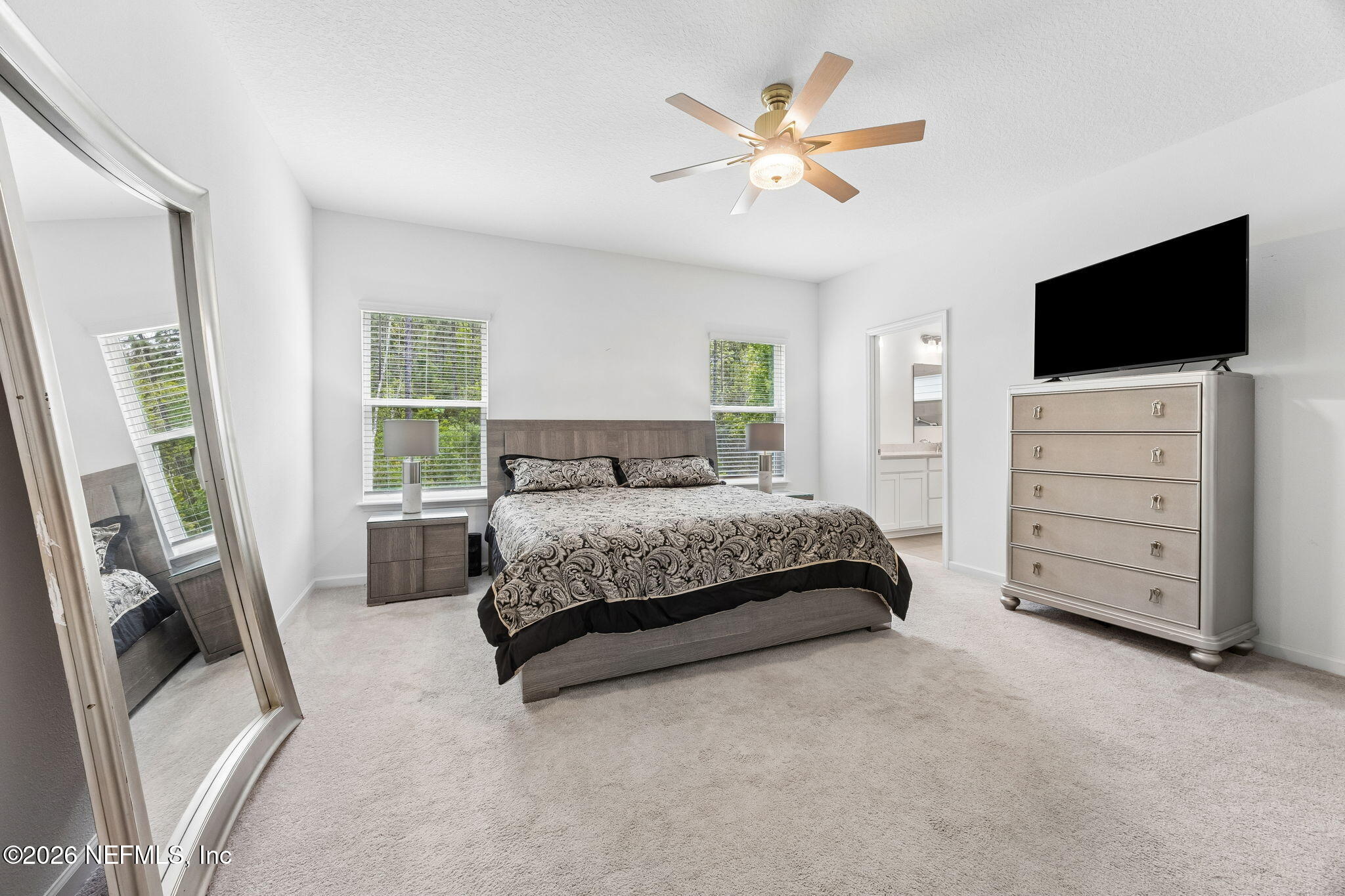 75626 Pondside Lane Yulee, FL 32097 - Photo 28 of 95 a bedroom with a bed window and a flat screen television