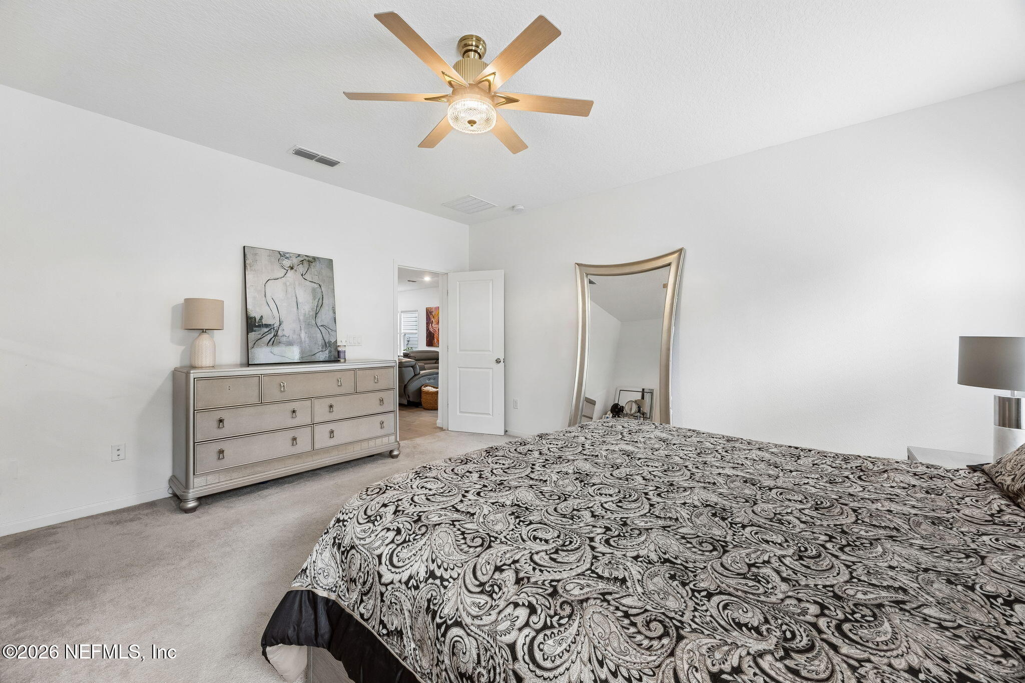 75626 Pondside Lane Yulee, FL 32097 - Photo 32 of 95 a bedroom with a bed and a dresser