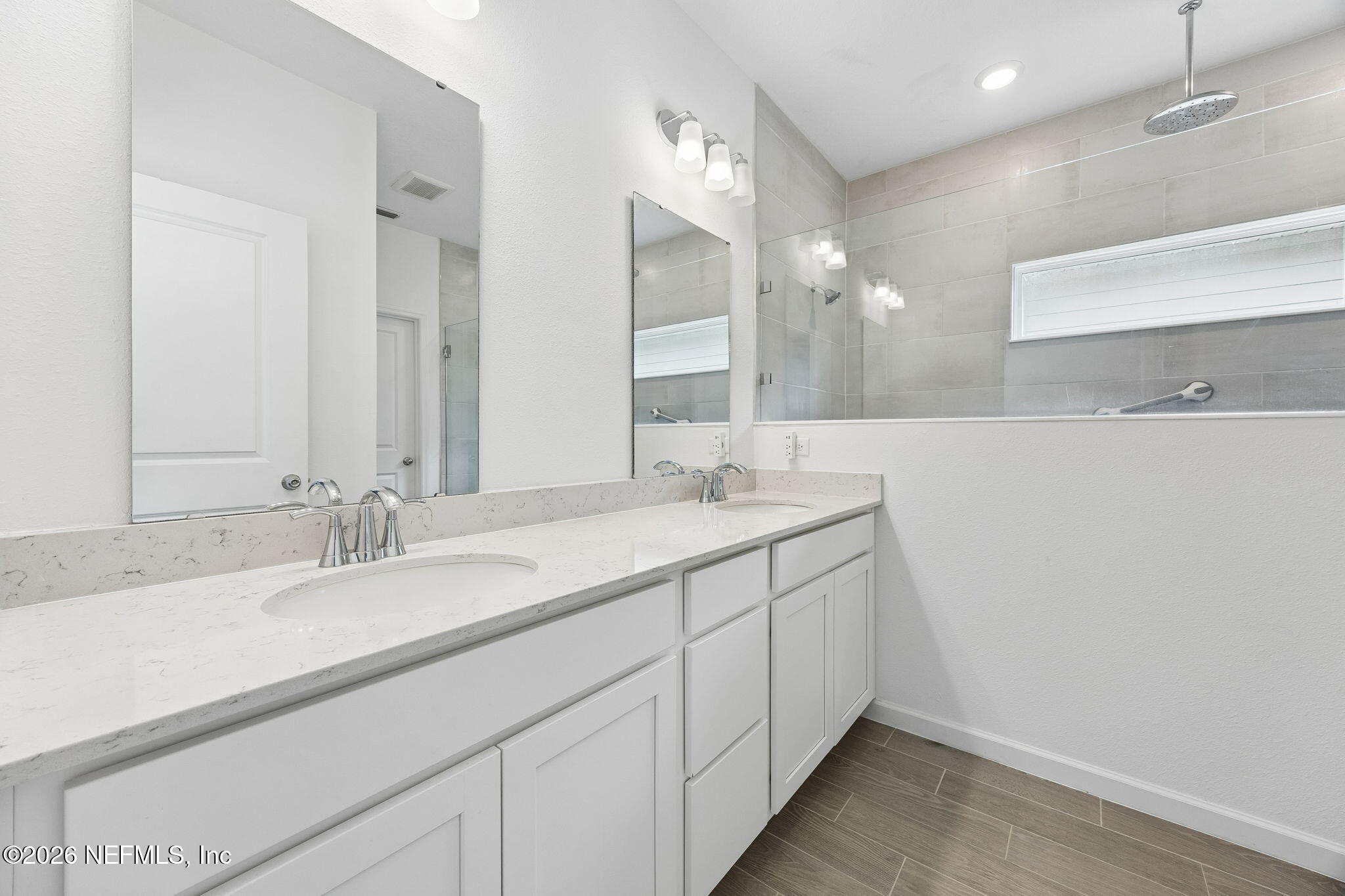75626 Pondside Lane Yulee, FL 32097 - Photo 33 of 95 a bathroom with a sink and a mirror