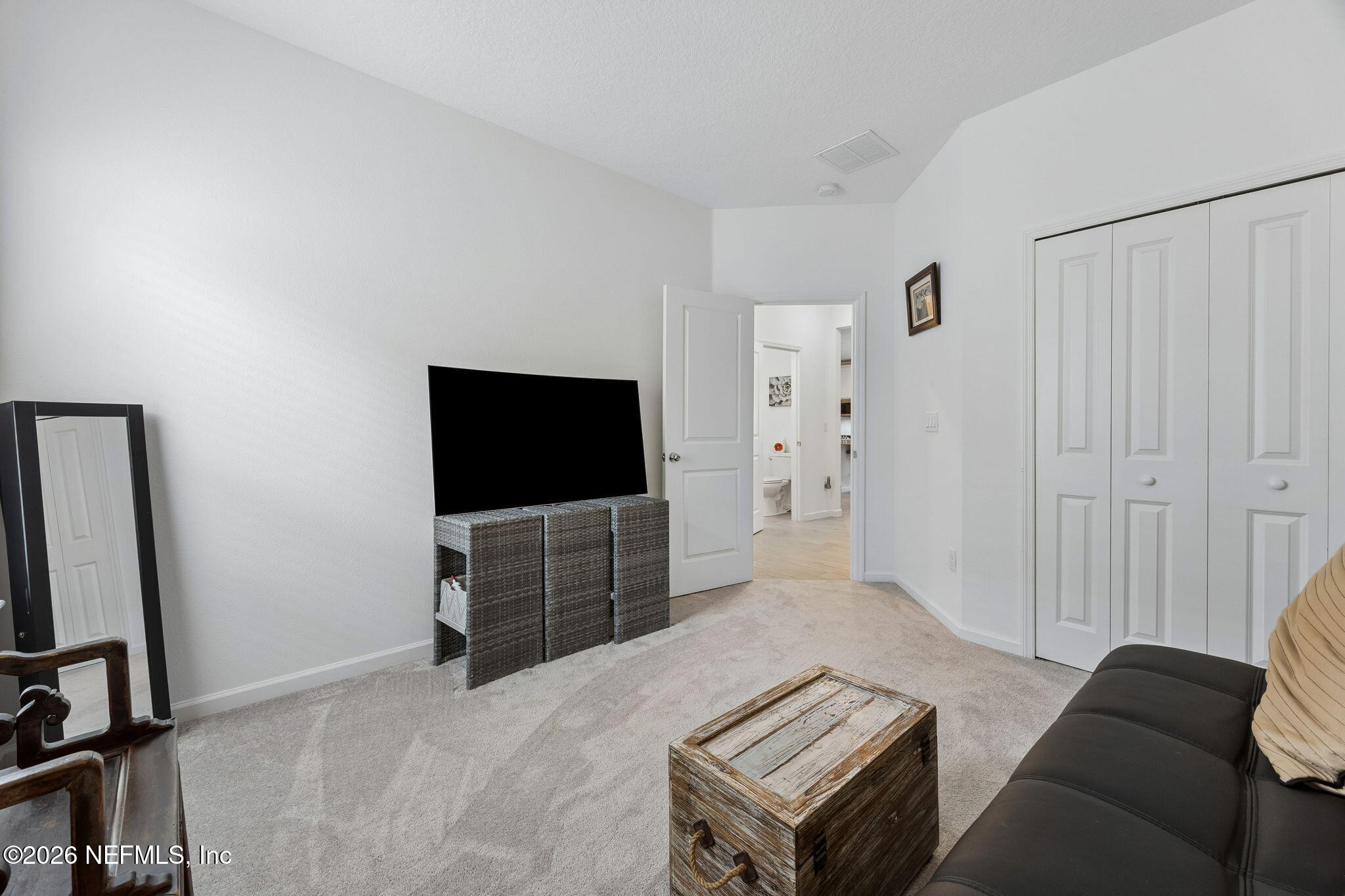 75626 Pondside Lane Yulee, FL 32097 - Photo 38 of 95 a living room with furniture and a flat screen tv