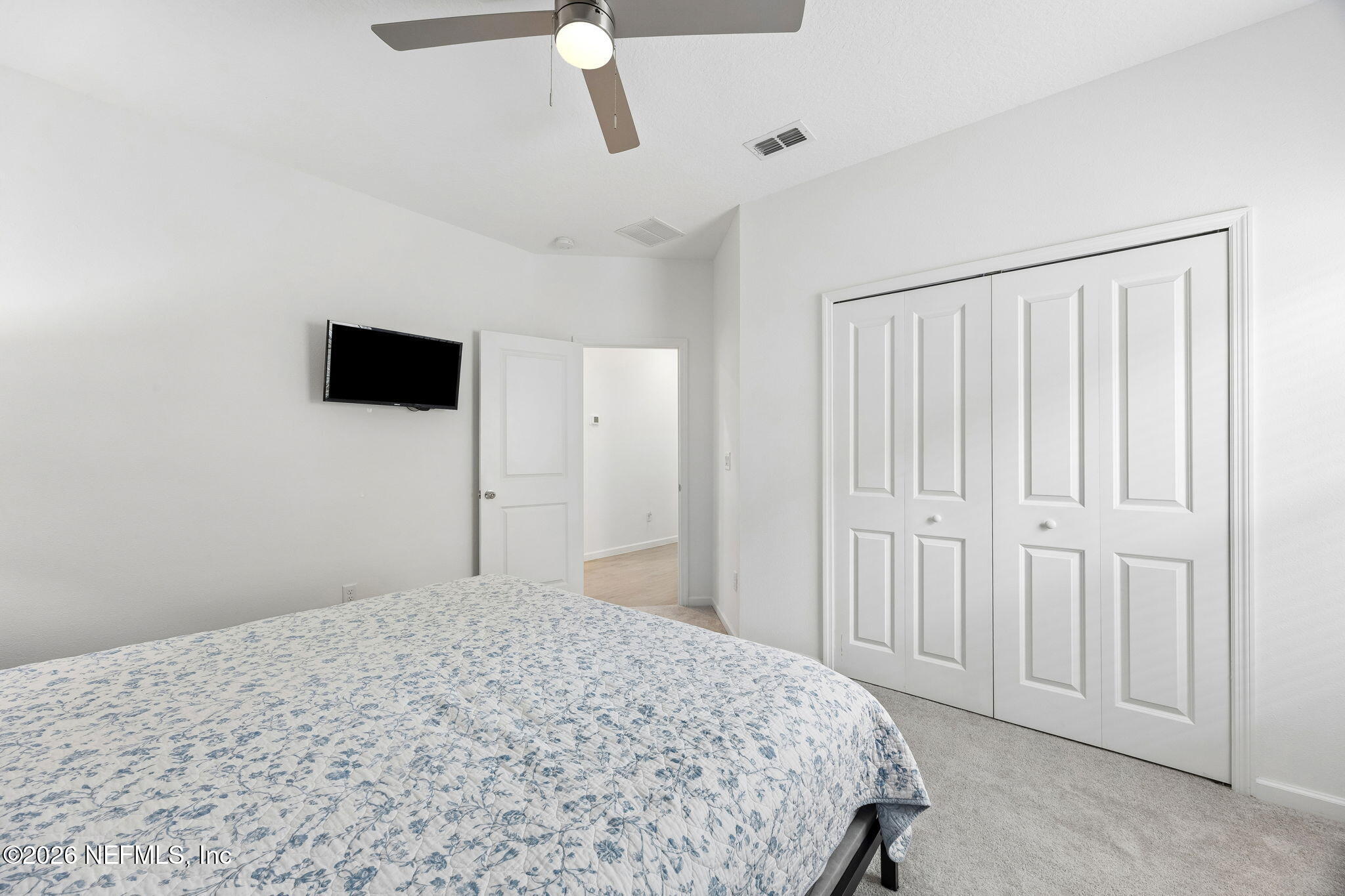 75626 Pondside Lane Yulee, FL 32097 - Photo 41 of 95 a bedroom with a bed and a flat tv screen