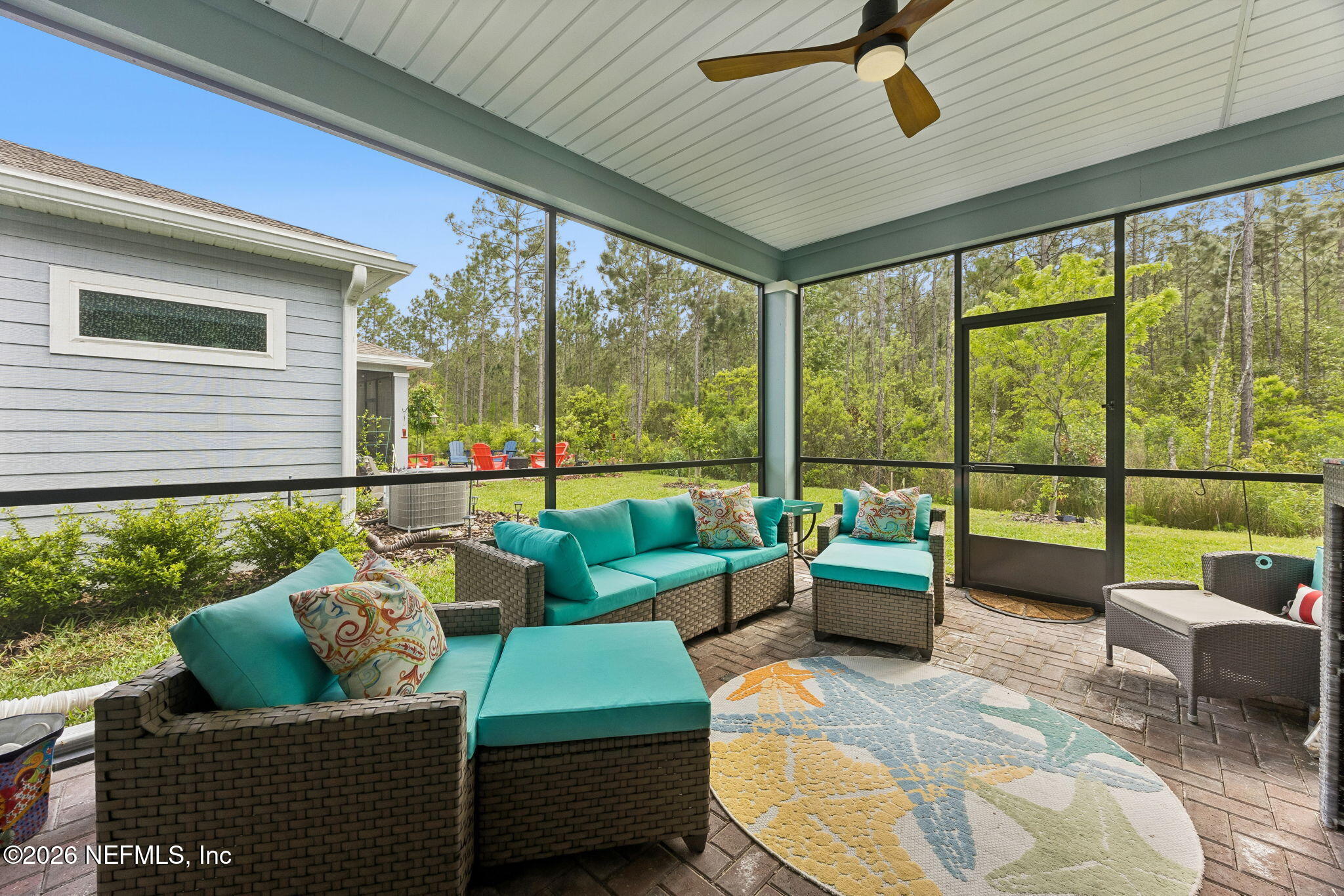 75626 Pondside Lane Yulee, FL 32097 - Photo 51 of 95 a living room with furniture and a large window