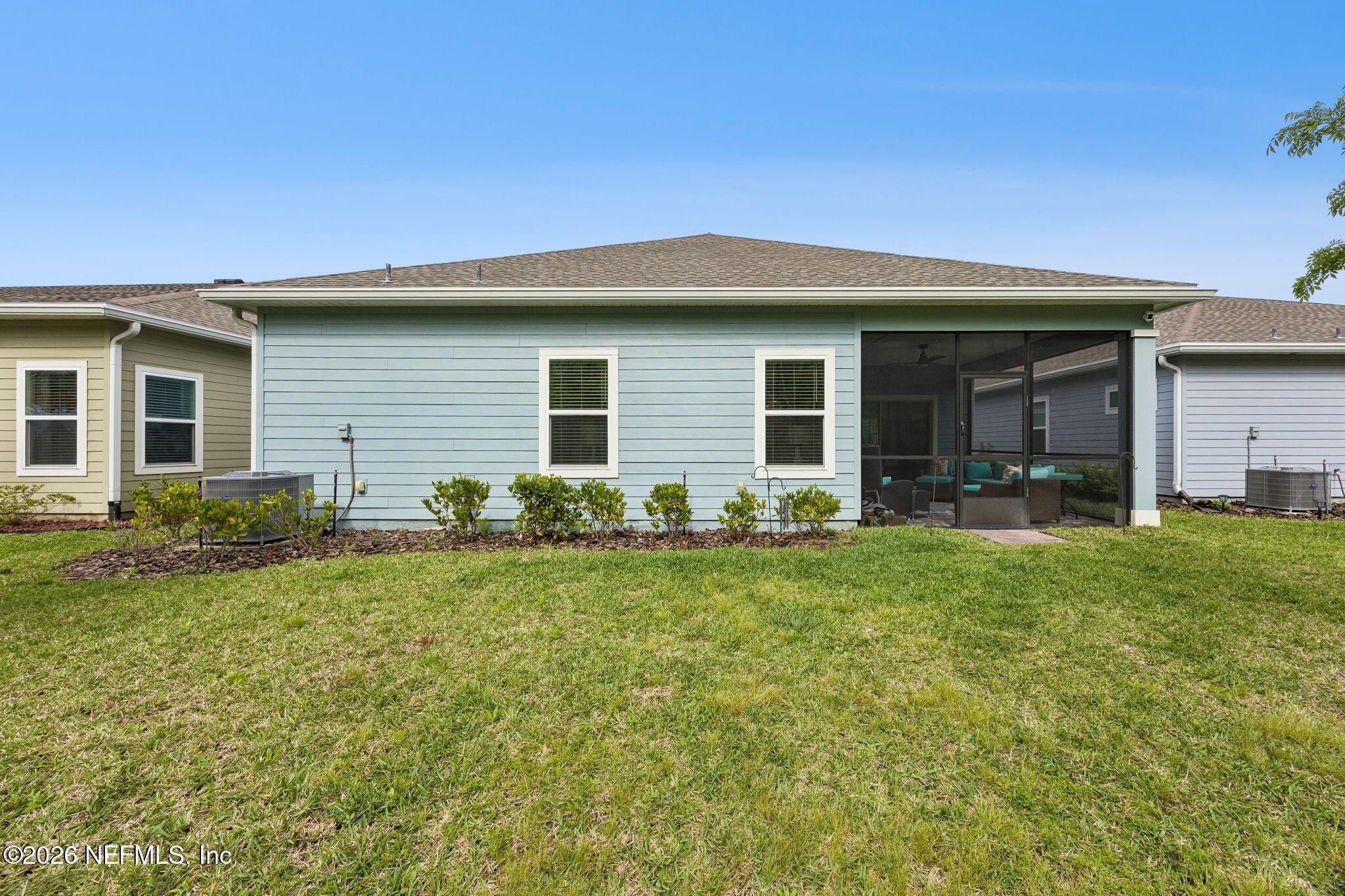 75626 Pondside Lane Yulee, FL 32097 - Photo 54 of 95 a front view of a house with a yard and garage