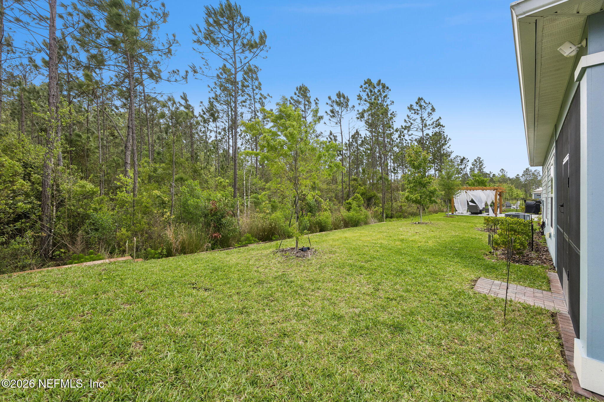 75626 Pondside Lane Yulee, FL 32097 - Photo 57 of 95 a backyard of a house with lots of green space