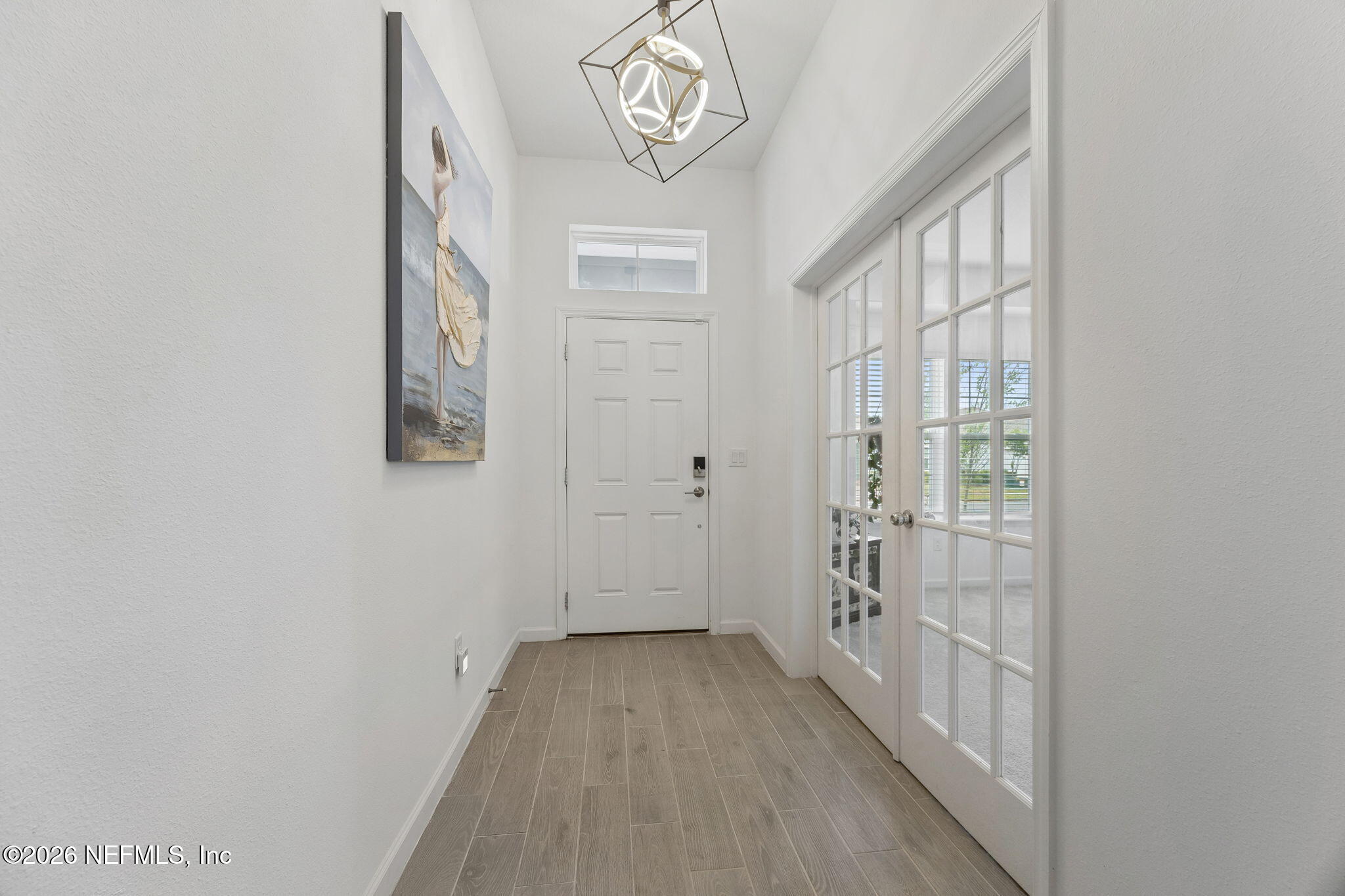 75626 Pondside Lane Yulee, FL 32097 - Photo 9 of 95 a view of an entryway with wooden floor