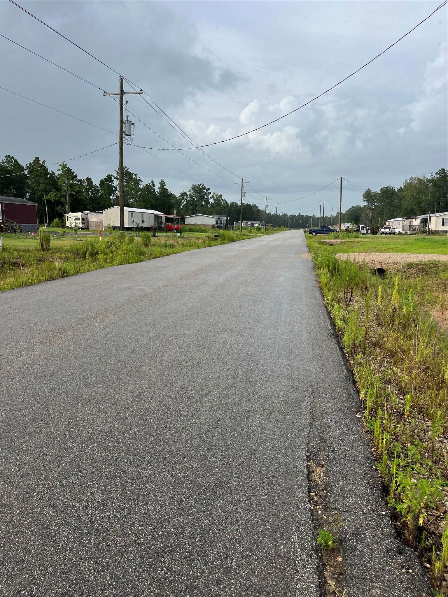 373-01 Splendora Tx 77372 Splendora, TX 77372 - Photo 3 of 12 a view of a lake with houses in the background