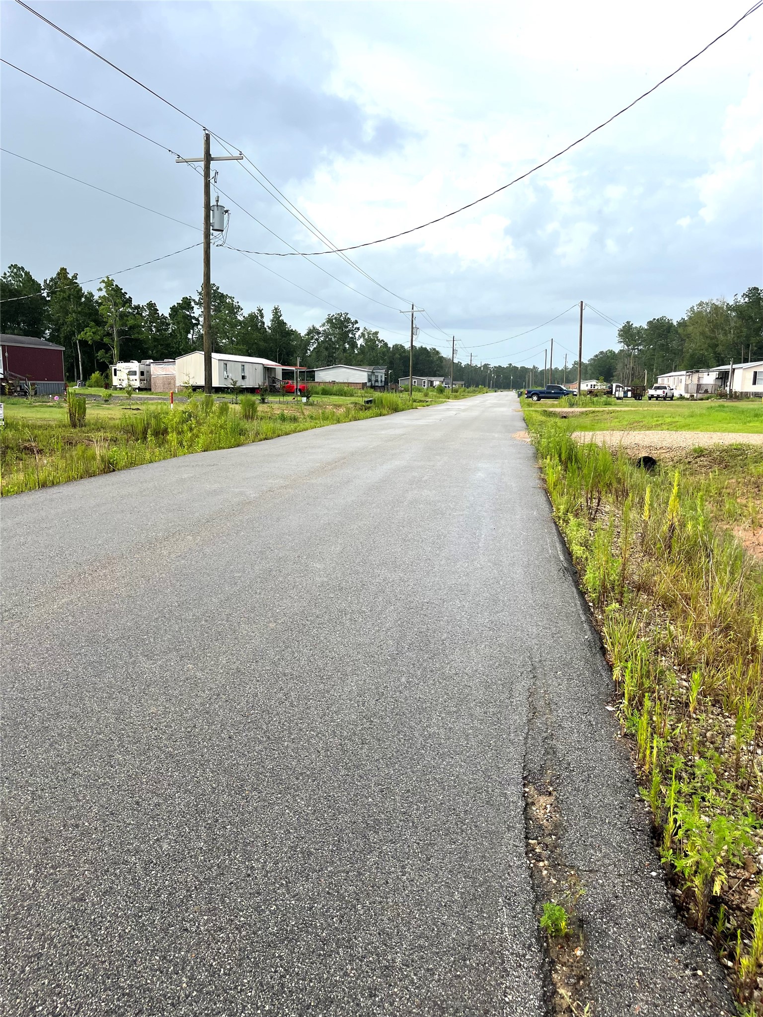 373-01 Splendora Tx 77372 Splendora, TX 77372 - Photo 10 of 12 a view of a lake with houses in the background