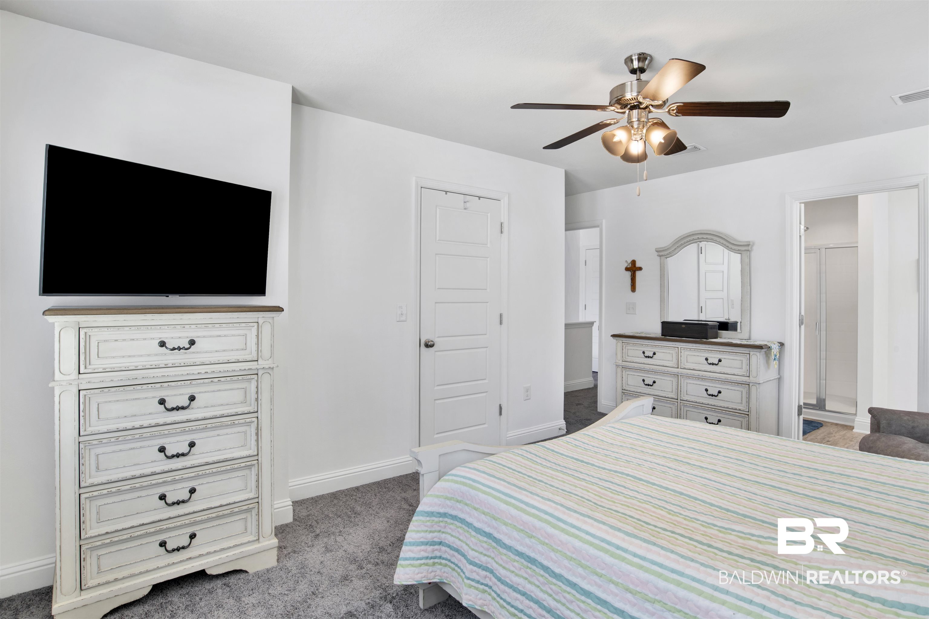 25806 Pollard Road, Unit 20 Daphne, AL 36526 - Photo 14 of 29 Carpeted bedroom featuring ensuite bathroom and ceiling fan